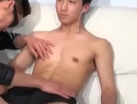 A young and attractive Japanese man gives a hand job.