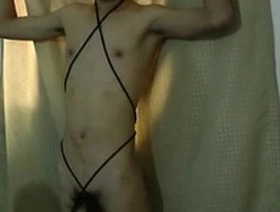 Young Asian man in BDSM bondage gets milked by his master